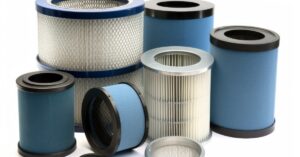 A group of cylindrical industrial air filters in various sizes, including blue foam and white pleated HEPA-style units.